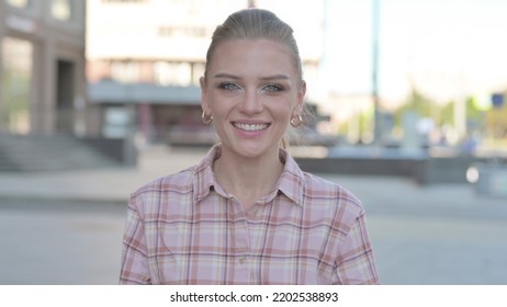 Portrait Of Agree Young Woman Shaking Head In Approval Outdoor