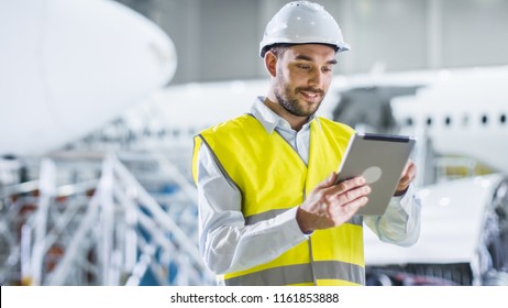 Portrait of Aircraft Maintenance Mechanic in Safety Vest using Tablet Computer - Powered by Shutterstock