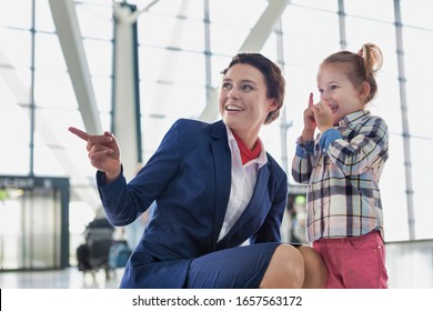 Portrait Of Airport Staff Playing With Cute Little Girl In Airport