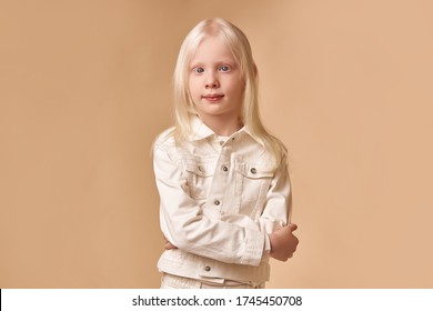 portrait of albino kid girl with white skin and white hair. Blonde girl with unusual natural beauty, albinism concept