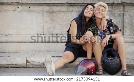 Portrait of an alternative gay couple with motorcycle helmets