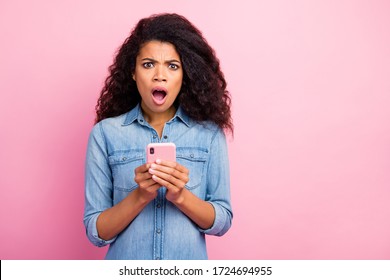 Portrait Of Amazed Social Media Lover Addicted Afro American Girl Blogger Use Smart Phone Get Dislike Scream Unbelievable Feel Impressed Wear Denim Outfit Isolated Pink Color Background