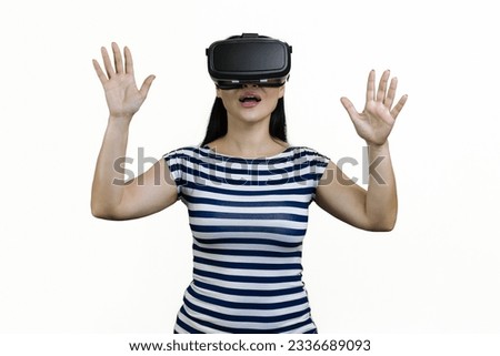 Portrait of amazed surprised woman having vr experience in headset. Both hands up. Isolated on white.