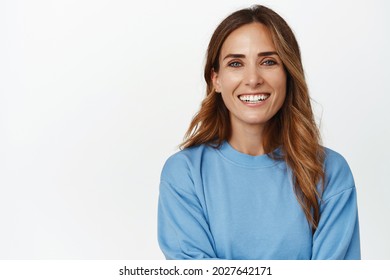 Portrait Of Ambitious And Confident Adult 30s Woman, Cross Arms And Smiling Happy At Camera, Looking Forward, Standing Against White Background