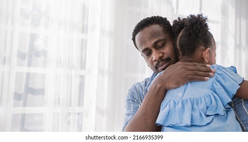 Portrait Of American African Father Daughter Hugging Laughing In Living Room. Happy Daddy And Little Girl Spending Leisure Time At Home. Single Dad, Family Lifestyle Father's Day Concept Banner