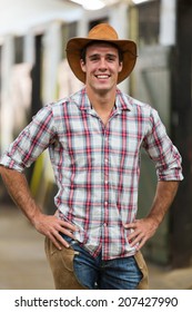portrait of american cowboy standing in stables