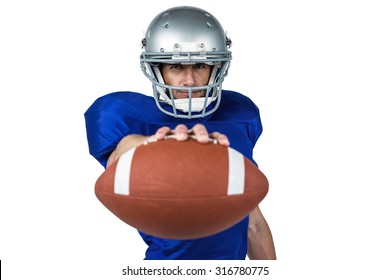 Portrait of American football player holding ball against white background - Powered by Shutterstock