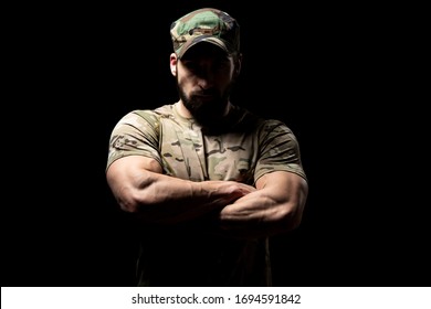 Portrait Of A American Marine Corps Special Operations Modern Warfare Soldier Arms Crossed With Cap On Black Background