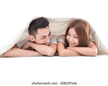 Portrait of amorous young people lying in bed