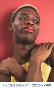 A Portrait Of An Androgynous Black Guy On A Red Background. LGBTI Concept