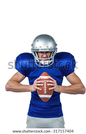 Portrait of angry American football player holding ball on white background