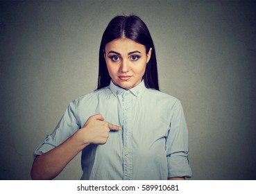 Portrait Of Angry Annoyed Woman Asking You Talking To Me, You Mean Me? Isolated On Gray Wall Background