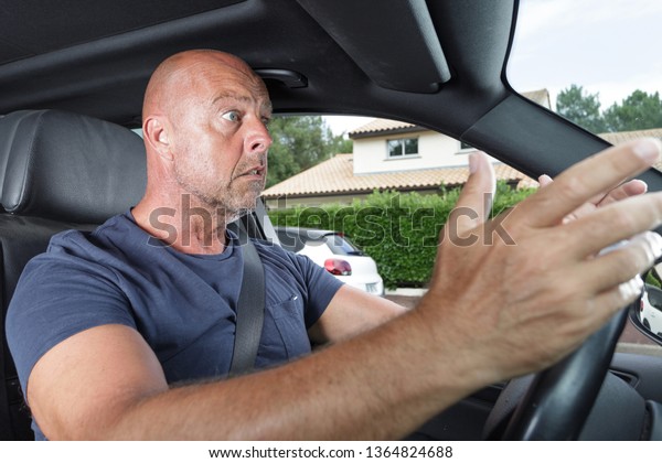 portrait of an\
angry driver yelling in his\
car