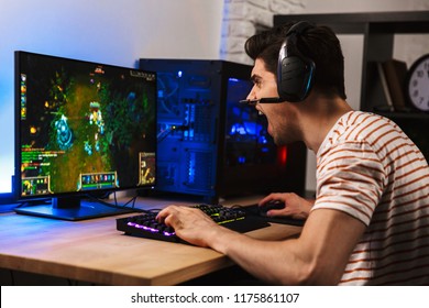 Portrait Of Angry Gamer Guy Wearing Headset Yelling While Playing Video Games On Computer