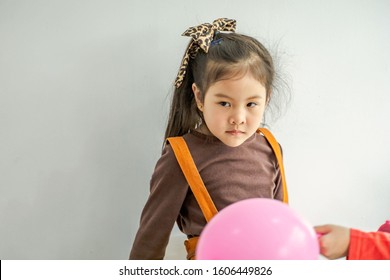 Portrait Of An Angry Little Young Girl In The Party.  Sad, Upset, Grumpy, Stressed, Unhappy Girl 4-6 Years Old. 