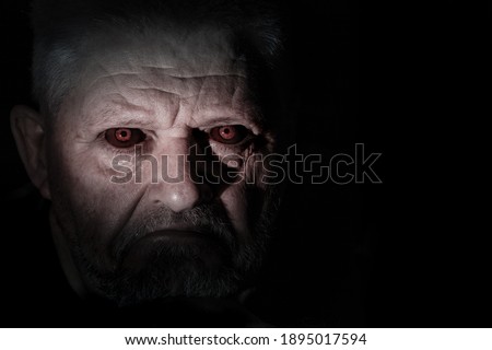 Portrait of an angry looking man with black eyes