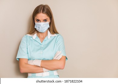 Portrait Of Angry Nurse With Protective Mask  And Gloves.