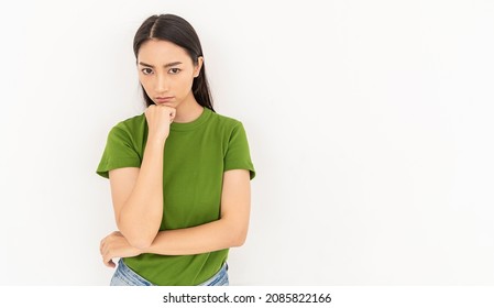 Portrait of angry pensive mad crazy stress angry asian woman in green t-shirt (expression, facial), cry girl, beauty portrait of young panic burnout drama asian woman isolated on white background.