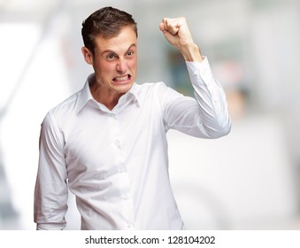 Portrait Of Angry Young Man Clenching His Fist, Outdoor