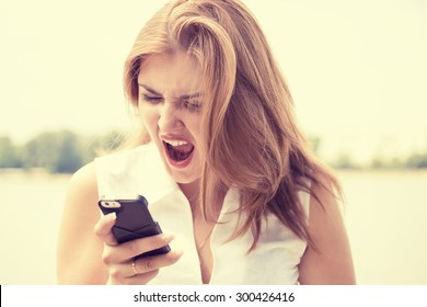 Portrait Angry Young Woman Screaming On Mobile Phone Standing Outside With City Background. Negative Emotions Feelings 