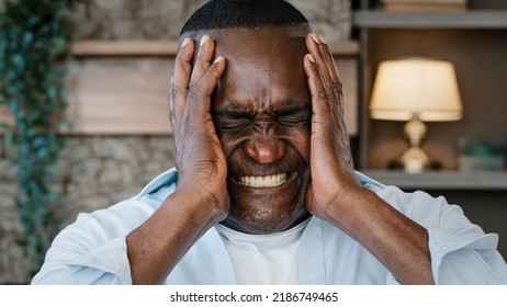 Portrait of annoyed african american adult man angry furious senior elder businessman shouts NO covers ears with hands much noise feels panic attack mad furious about loud music disturbing noisy