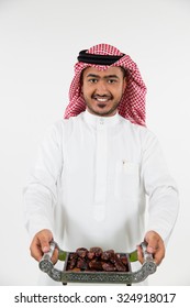 Portrait Of Arab Man Holding Dates On Tray