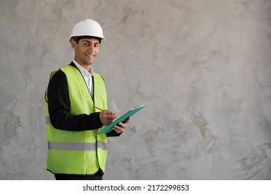 portrait of arabic man civil engineer with white safety hat, isolated on grey.