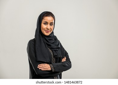 Portrait of arabic woman with traditional abaya dress in a studio