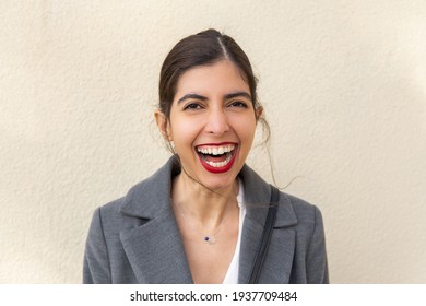 Portrait Of Arabic Women With A Big Beautiful Smile And Red Lipstick Isolated On Yellow Background 