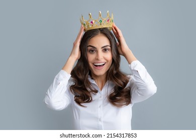 Portrait Of Arrogance Woman With Golden Crown On Head, Leadership And Success. Attractive Rich Arrogant Girl Wearing Crown Isolated Over Gray Background.