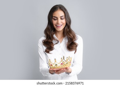 Portrait Of Arrogance Woman With Golden Crown On Head, Leadership And Success. Attractive Rich Arrogant Girl Wearing Crown Isolated Over Gray Background.