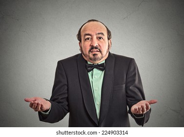 Portrait Arrogant Clueless Middle Aged Business Man Arms Out Asking What's Problem Who Cares So What I Don't Know Isolated Grey Wall Background. Negative Human Emotion Facial Expression Body Language