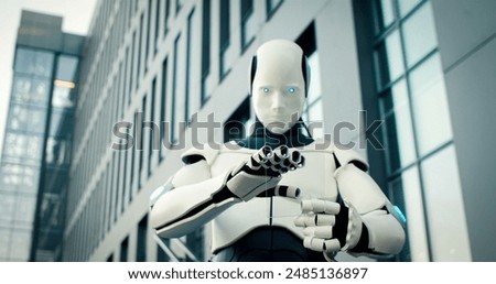 Portrait of artificial intelligence machine holds innovative device in iron hands. Robot use latest technology gadget.