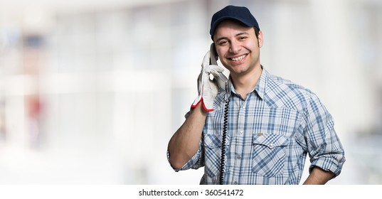 Portrait Of An Artisan Talking On The Phone. Large Copy-space