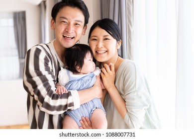 Portrait Of Asain Family In Living Room