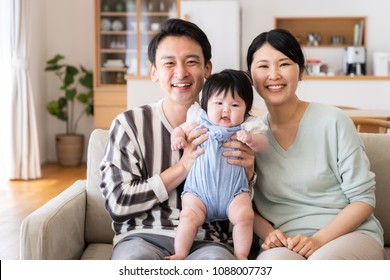 Portrait Of Asain Family In Living Room