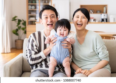 Portrait Of Asain Family In Living Room