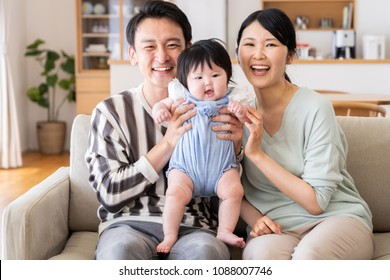 Portrait Of Asain Family In Living Room