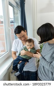 Portrait Of Asain Family In Living Room