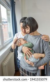 Portrait Of Asain Family In Living Room