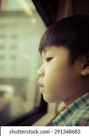 Portrait of asia boy looking out the window / Looking to the future