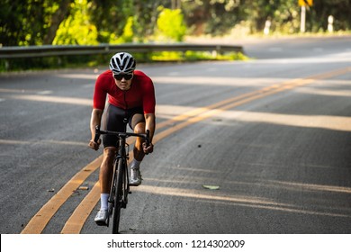 Portrait Of Asia Cyclist In Red Jersey. Full Body Of Male Cyclist On His Road Bike