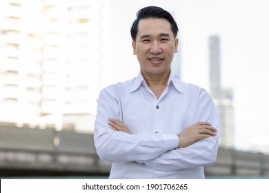 Portrait Asian Adult Man With Smile Face Confident Business Man In White Shirt Looking At Camera While Standing Outdoors In City Handsome Guy Get Happy He Get Successful Of Life Mature Male Concept