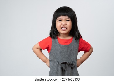 Portrait Of Asian Angry And Sad Little Girl On White Isolated Background, The Emotion Of A Child When Tantrum, Expression Grumpy Emotion. Kid Emotional Control Concept