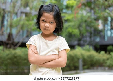 Portrait of an Asian angry and sad little girl. The emotion of a child when tantrum and mad, expression of grumpy emotion. Kid emotional control, attention deficit hyperactivity disorder concept ADHD - Powered by Shutterstock