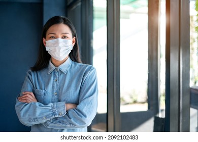 Portrait Of Asian Attractive Modern Businesswoman Standing In The Office Wearing A Protective Mask, Smile With Confidence. Happy Young Beautiful Boss And Professional CEO Work On A New Business Idea.