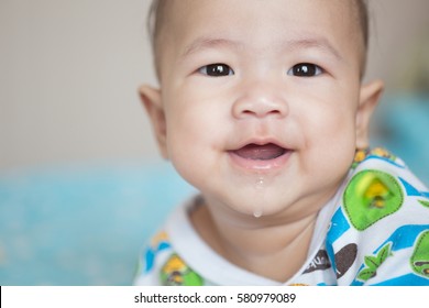 Portrait Of Asian Baby Girl Smiling And Drooling