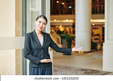 Portrait Of Asian Beautiful Manager In Formal Wear Standing Near The Entrance And Inviting You To The Hotel