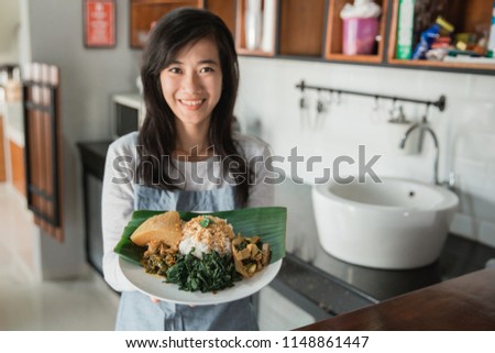 portrait of asian beautiful woman carrying nasi padang indonesian traditional food