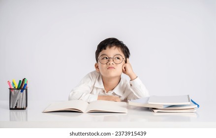 Portrait of an Asian boy studying on a white background - Powered by Shutterstock